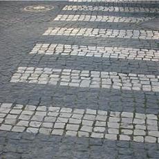Black and white cobbles are used for form a pedestrian crossing, Lisbon