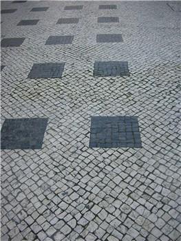 Black squares set in white cobbles laid on the diagonal, Lisbon